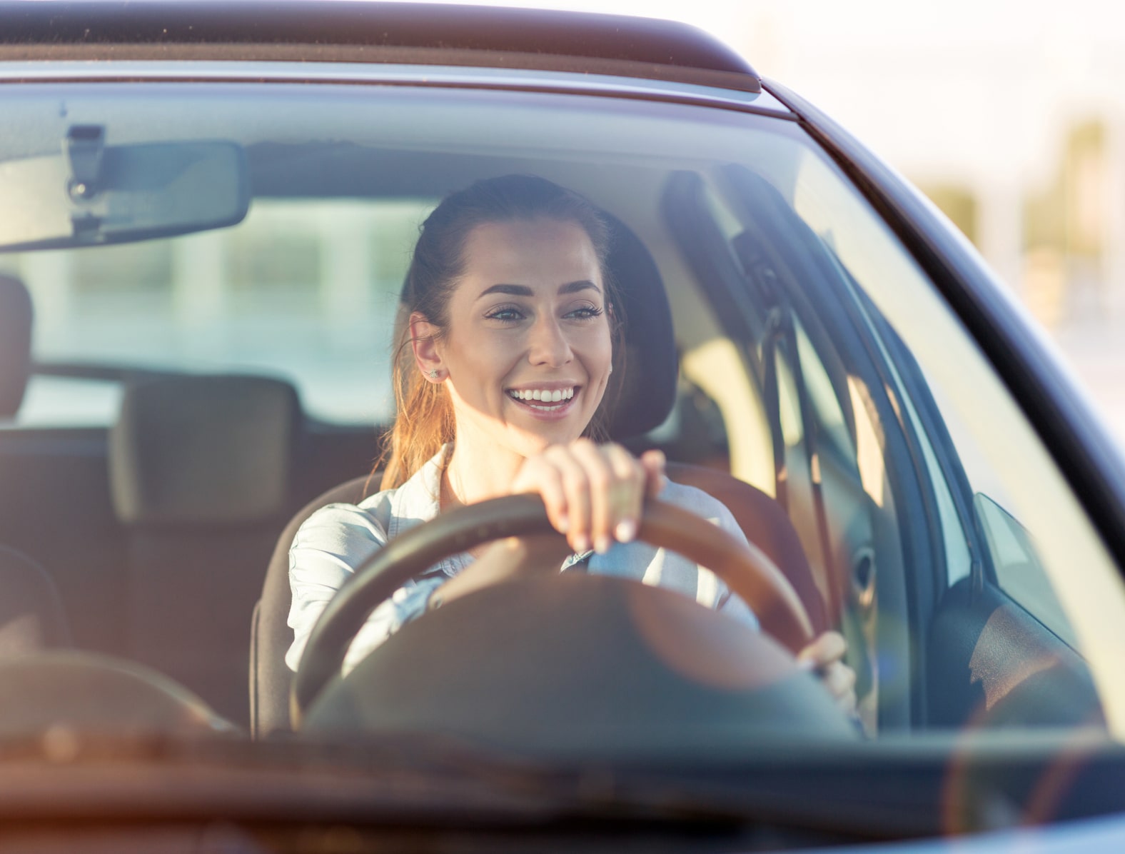 woman driving and smiling
